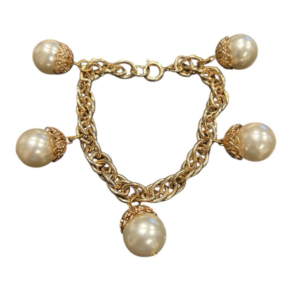 Gold tone bracelet with 5 gold capped pearl charms. 7”. JB1